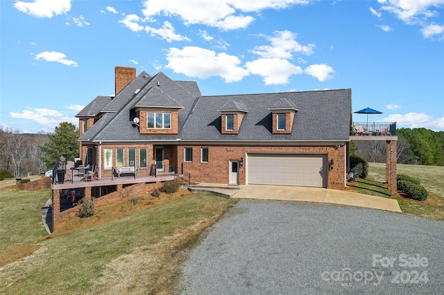 view of front of house featuring a front yard, a porch, and a garage