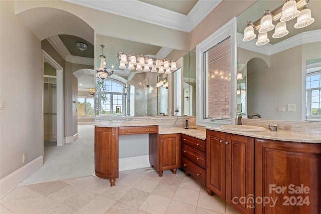 bathroom with vanity, ornamental molding, and a healthy amount of sunlight