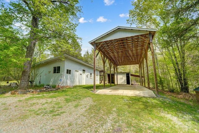 back of house with a yard and a shed