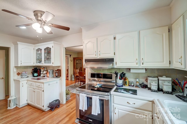 kitchen with double oven range, ceiling fan, light hardwood / wood-style flooring, and white cabinetry