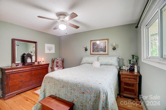 bedroom featuring light hardwood / wood-style floors and ceiling fan