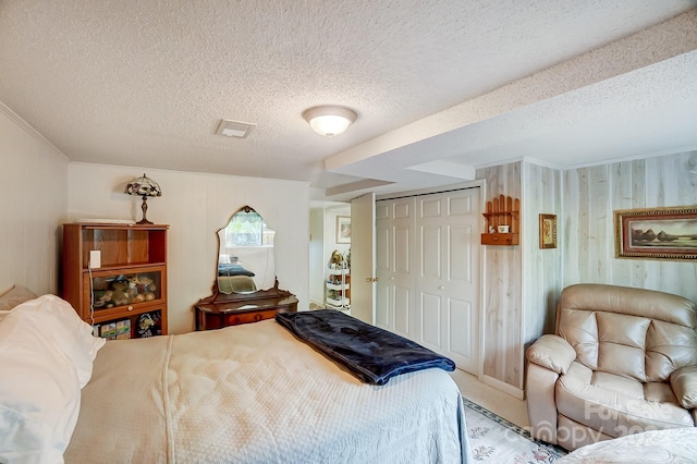 bedroom with a closet and a textured ceiling