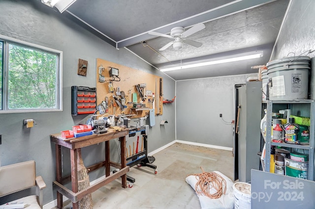 miscellaneous room with concrete floors, ceiling fan, lofted ceiling, and a workshop area