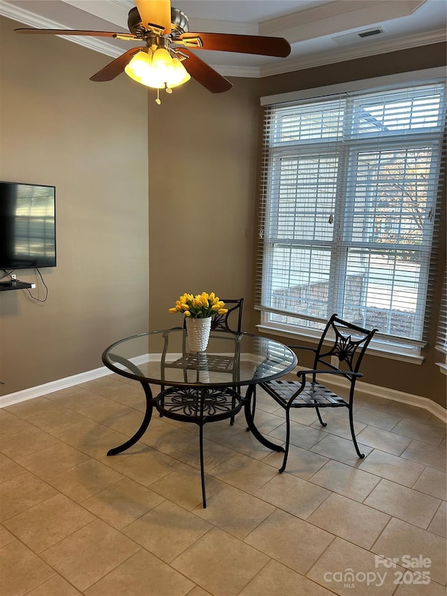 dining area featuring crown molding and light tile patterned floors