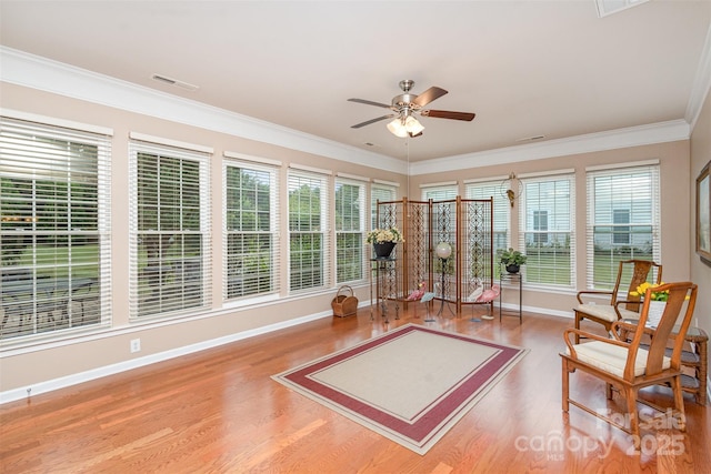 sunroom / solarium featuring plenty of natural light and ceiling fan