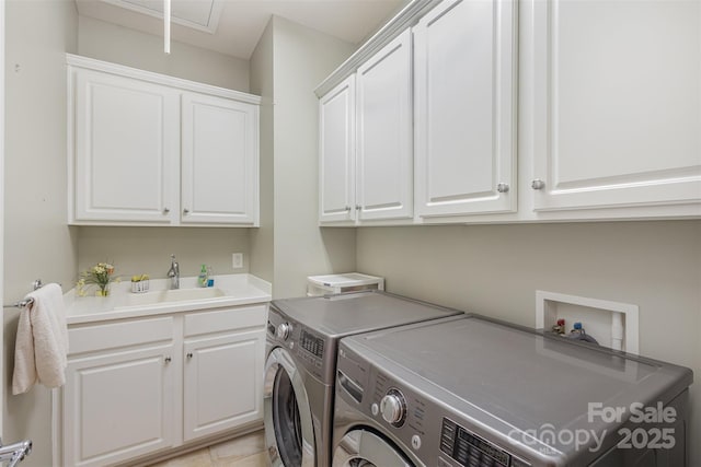 laundry area with cabinets, sink, and washer and dryer