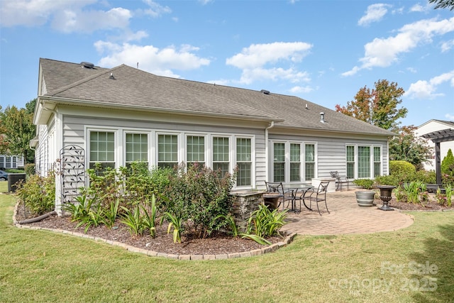 rear view of house featuring a patio area and a lawn