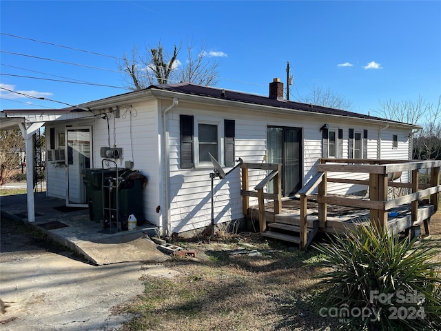 view of front of house featuring a wooden deck and cooling unit