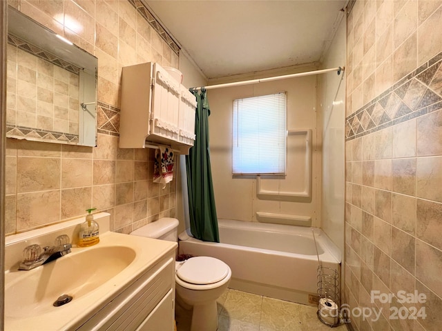 full bathroom with vanity, shower / bath combo, tile patterned floors, toilet, and tile walls