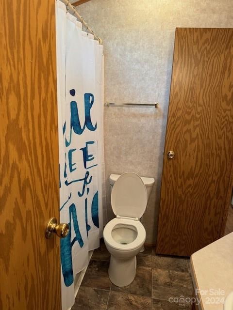 bathroom with tile floors and toilet