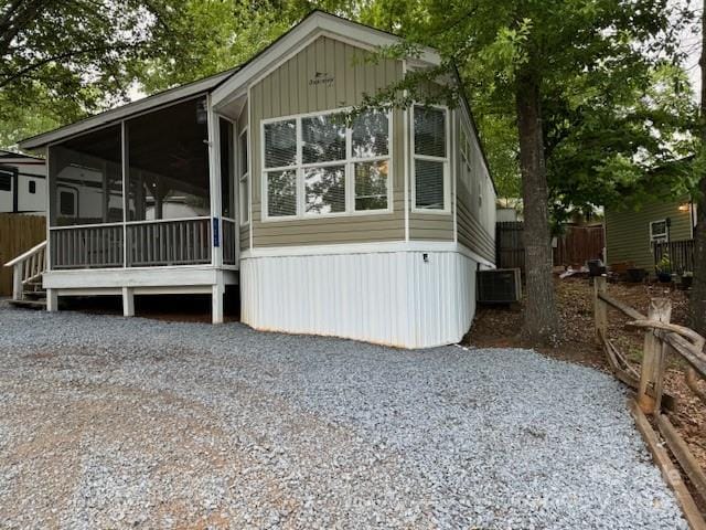 view of side of home featuring a sunroom