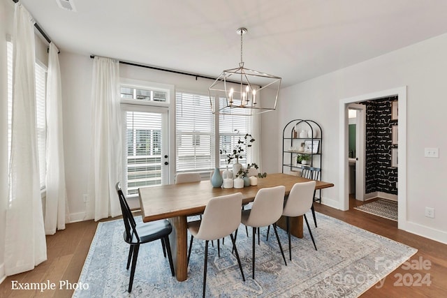 dining room with a chandelier and hardwood / wood-style floors