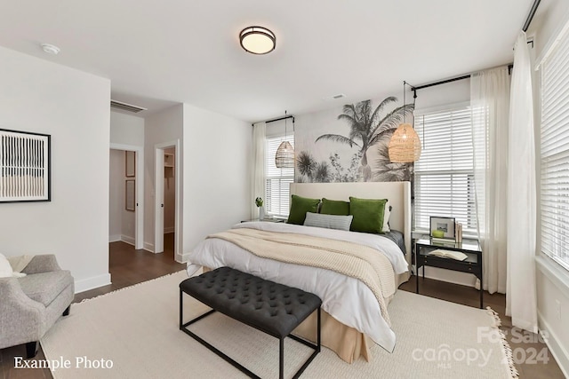 bedroom with dark wood-type flooring