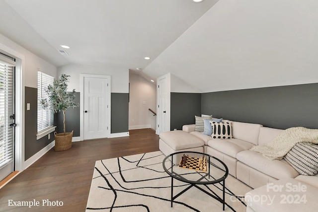 living room featuring vaulted ceiling and dark hardwood / wood-style flooring