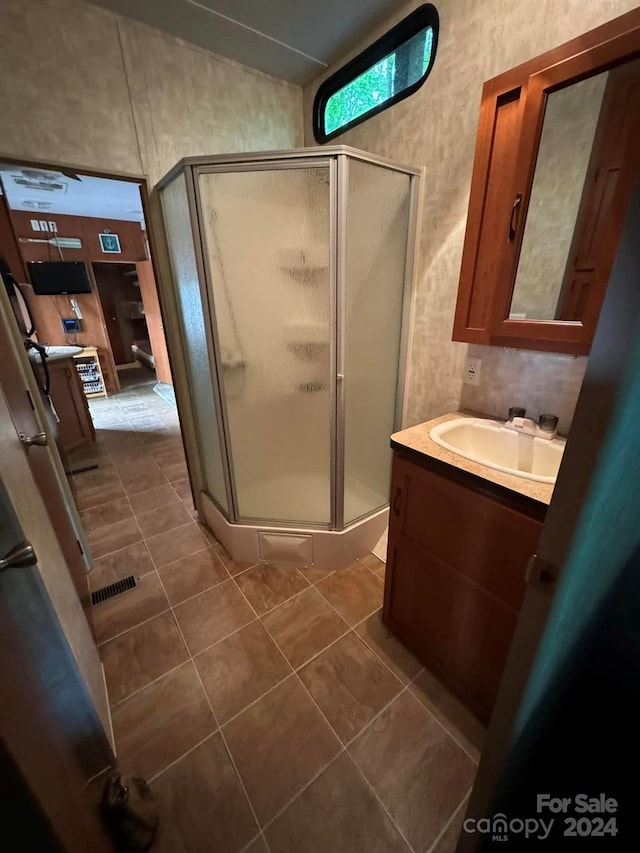 bathroom with vanity, tile patterned floors, and walk in shower