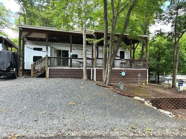 view of front of home with gravel driveway and a carport