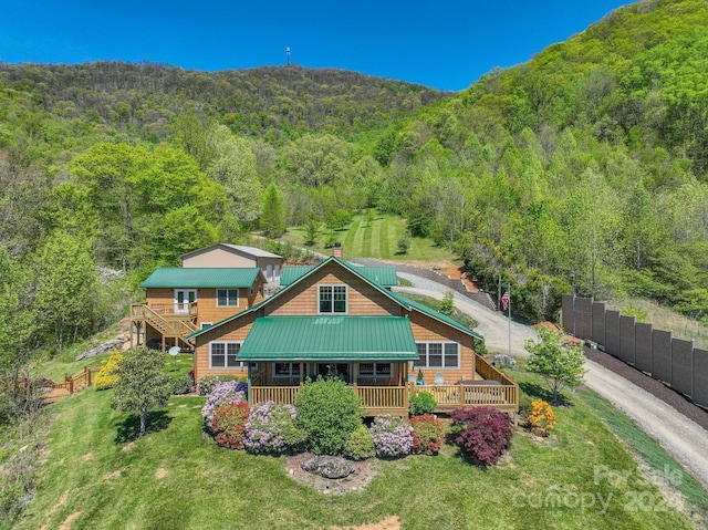 back of house featuring a wooden deck