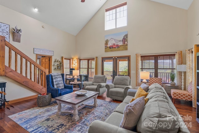 living room with dark hardwood / wood-style floors, high vaulted ceiling, and plenty of natural light