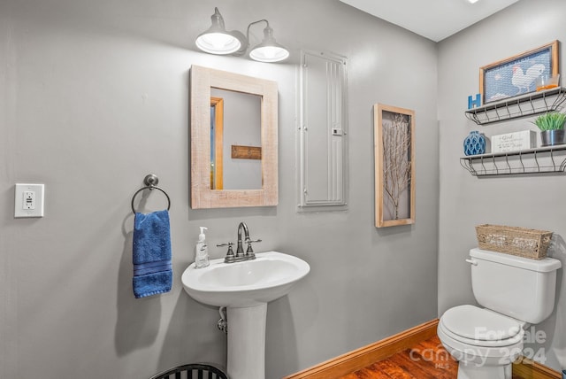 bathroom featuring hardwood / wood-style floors and toilet