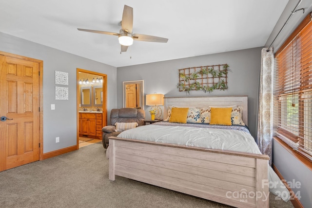 bedroom with light carpet, connected bathroom, and ceiling fan