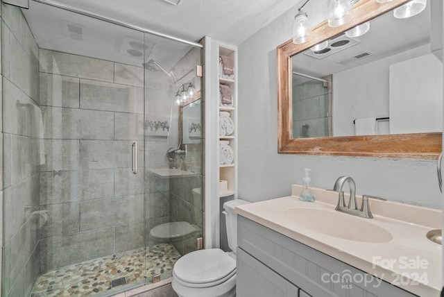 bathroom with walk in shower, toilet, and large vanity