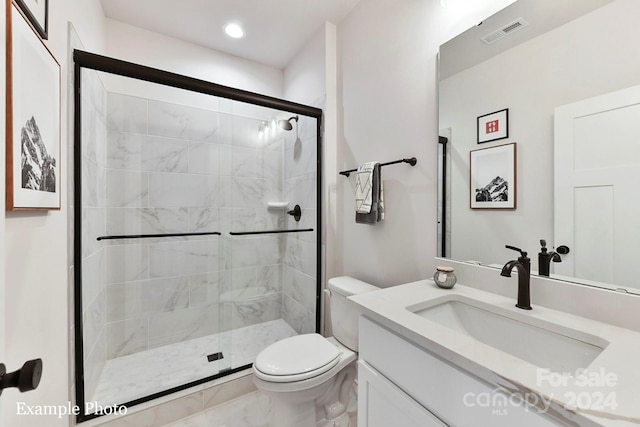 bathroom featuring a shower with door, toilet, oversized vanity, and tile flooring