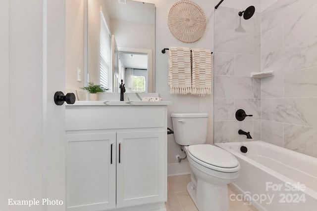 full bathroom featuring tiled shower / bath combo, large vanity, tile floors, and toilet