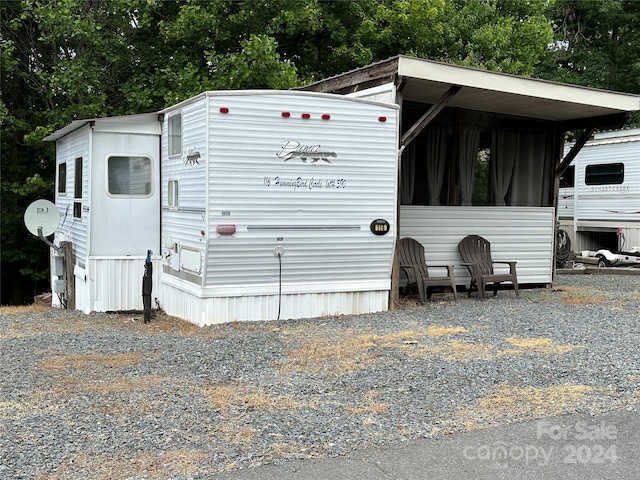 view of side of property with a carport