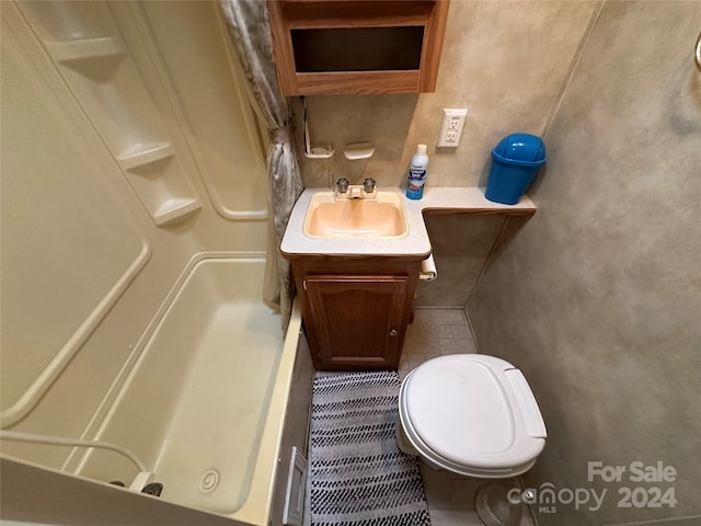 bathroom with vanity, tile floors, and toilet