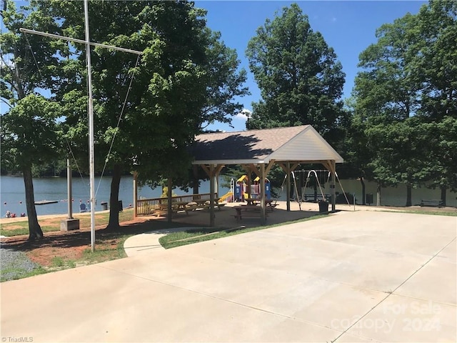 view of property's community featuring a gazebo, a playground, and a water view