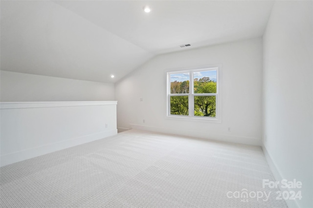 bonus room featuring light carpet and lofted ceiling