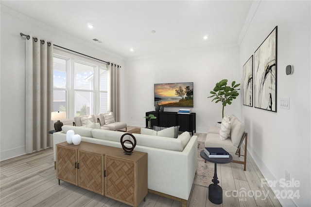 living room featuring light hardwood / wood-style flooring and ornamental molding