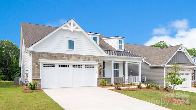 craftsman-style house with central AC, a front lawn, and covered porch