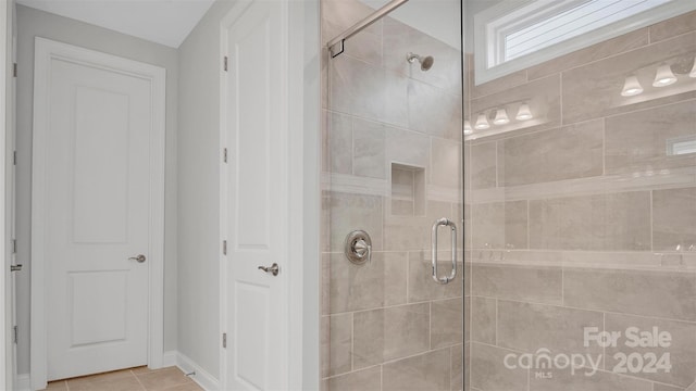 bathroom with tile patterned flooring and walk in shower