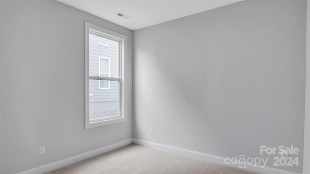 unfurnished room with light colored carpet