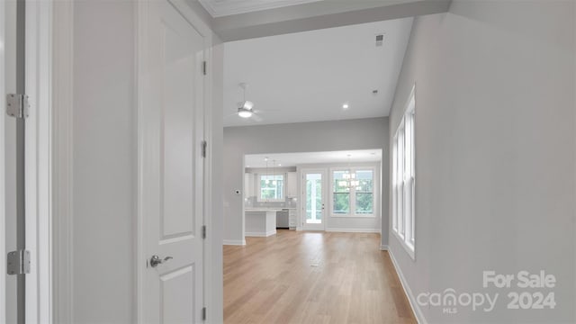 corridor with a chandelier and light hardwood / wood-style flooring