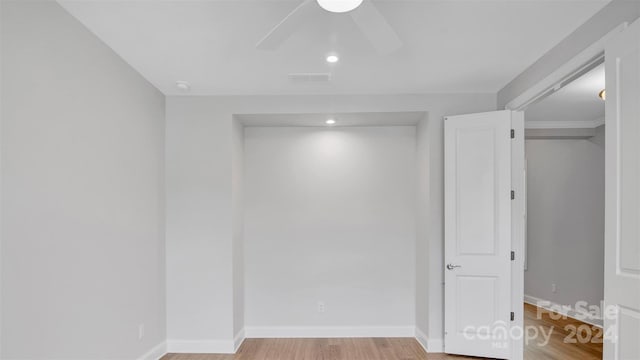 empty room with ceiling fan and light hardwood / wood-style floors