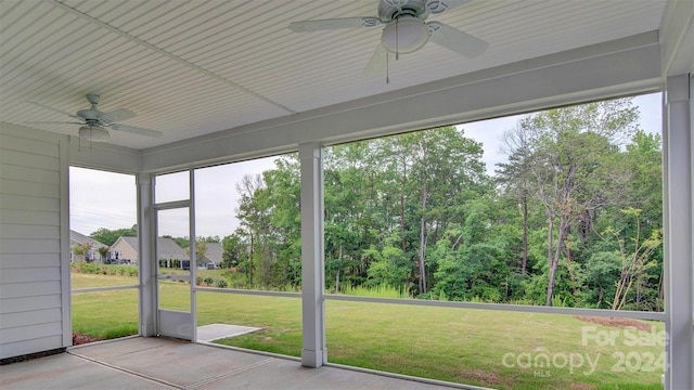 unfurnished sunroom with ceiling fan