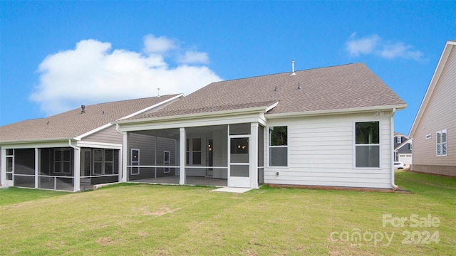 rear view of house featuring a patio, a yard, and a sunroom