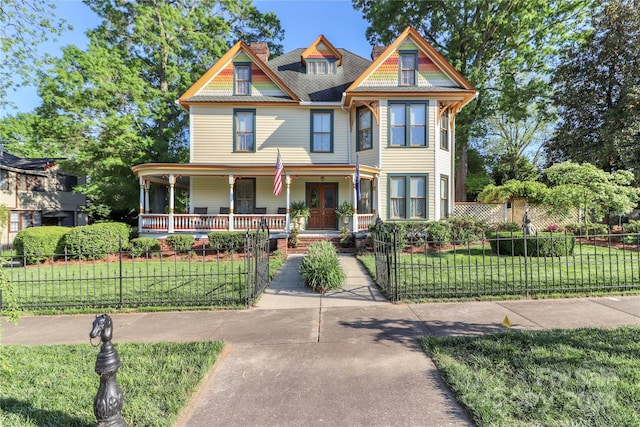 victorian home featuring a front yard and a porch