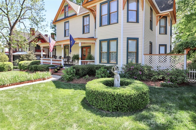 victorian-style house with a front lawn