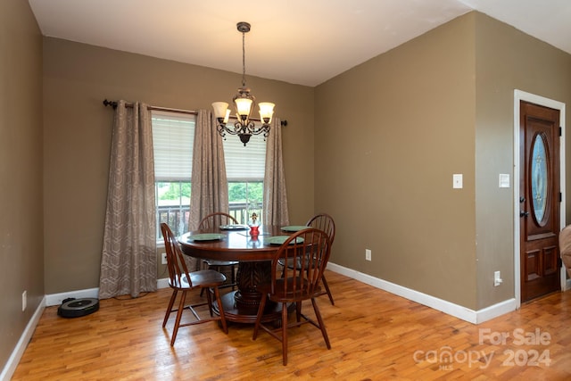 dining room featuring an inviting chandelier and light wood-type flooring