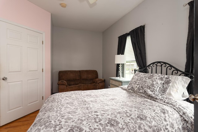 bedroom with wood-type flooring and ceiling fan