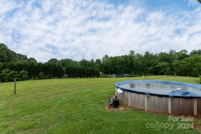 view of yard featuring a covered pool