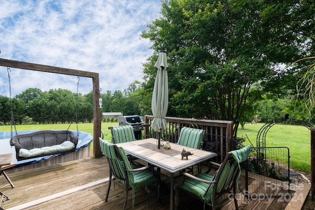 deck with a grill and a yard