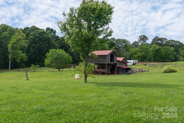 view of yard featuring a rural view and an outdoor structure