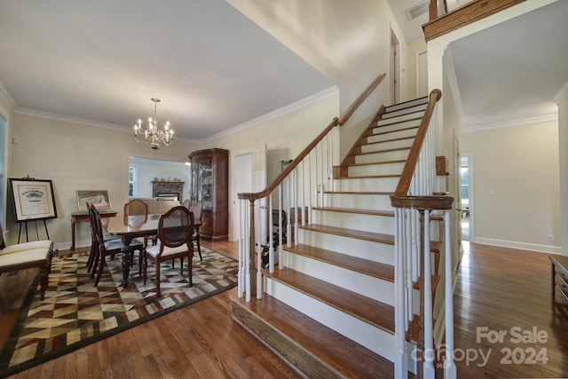 interior space with dark hardwood / wood-style floors, an inviting chandelier, and ornamental molding