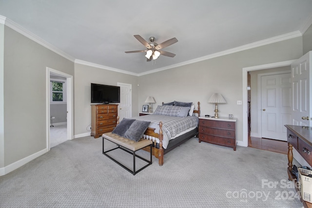 carpeted bedroom featuring ornamental molding and ceiling fan