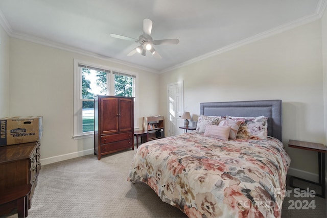 carpeted bedroom with ceiling fan and crown molding