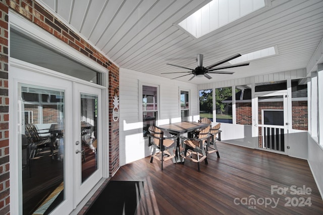 sunroom featuring a skylight, french doors, and ceiling fan